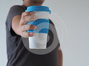 Zero wast concept.Hand holding stylish reusableÂ  eco coffee cup.